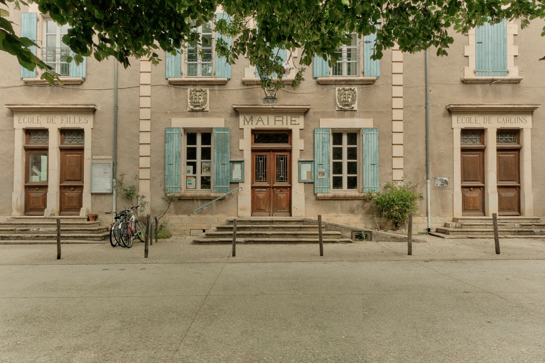 façade d'une mairie de village en Auvergne-Rhône-Alpes, volets bleus, vélos garés devant l'entrée